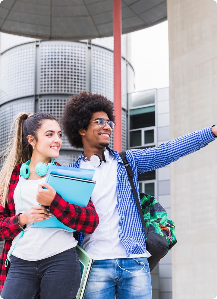 Male and female students standing outside a university building